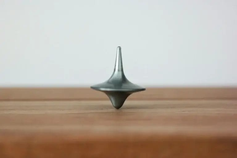 Spinning top balancing upright to represent nervous system regulation and equilibrium under pressure